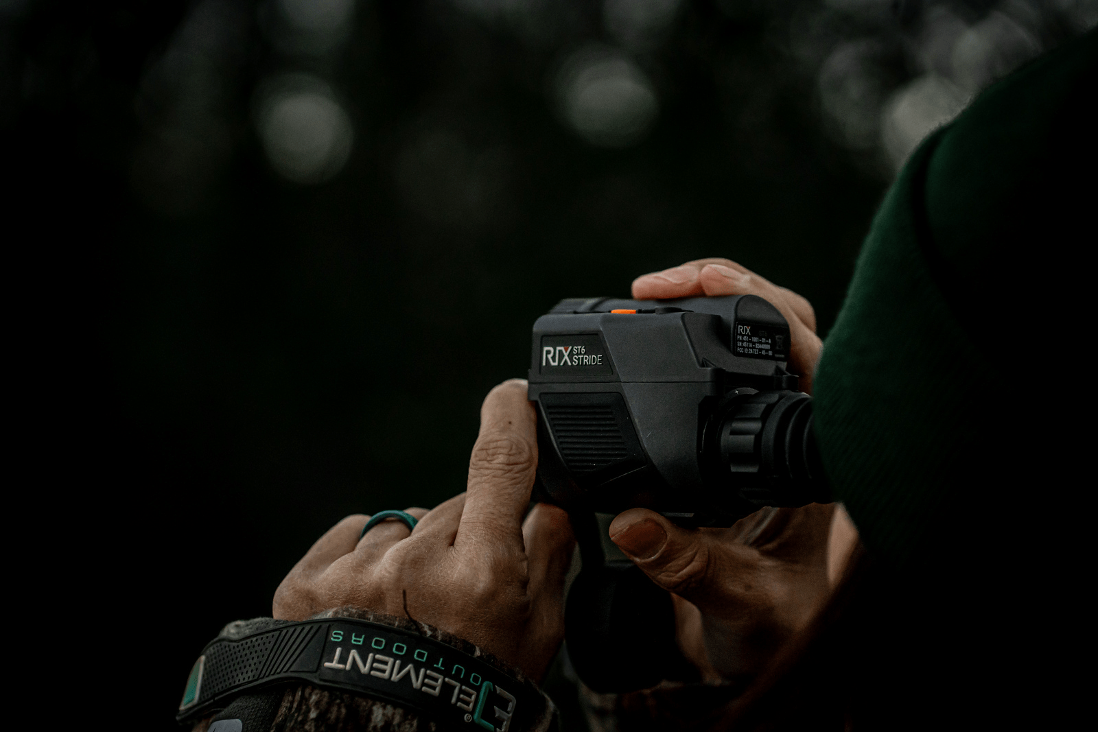 A hunter is aiming with a thermal imaging monocular.