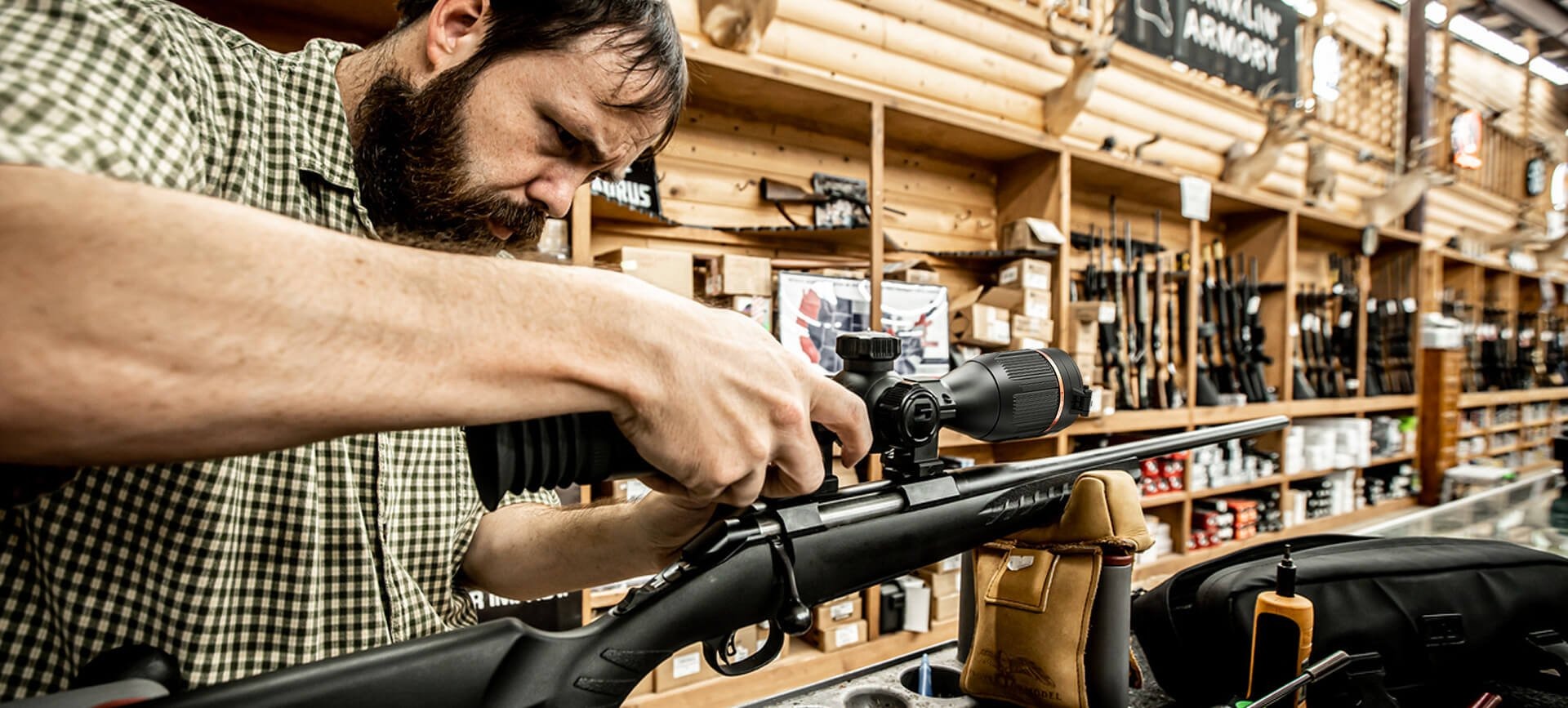 A hunter is mounting the thermal scope onto his rifle